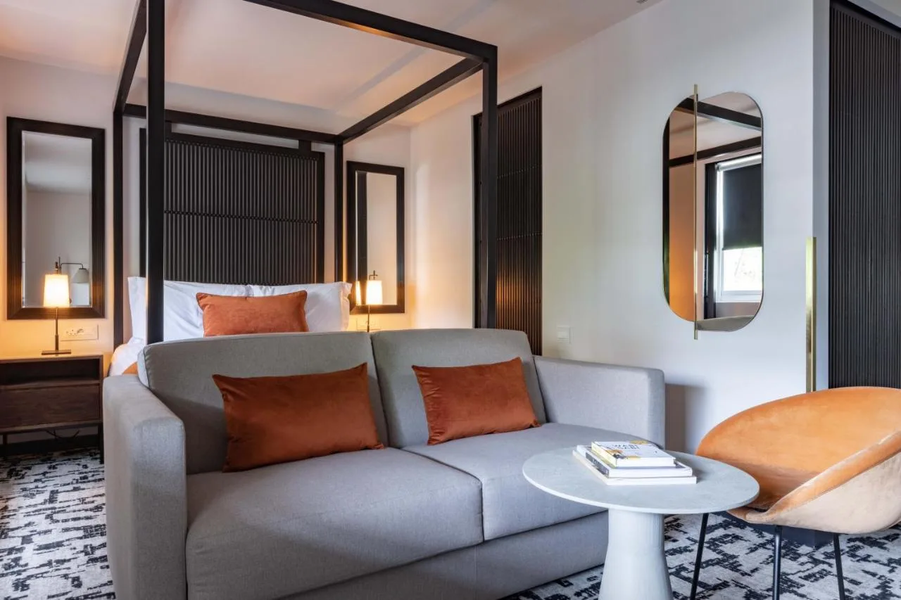 a living room with a couch and a bed at La Suite West - Hyde Park in London