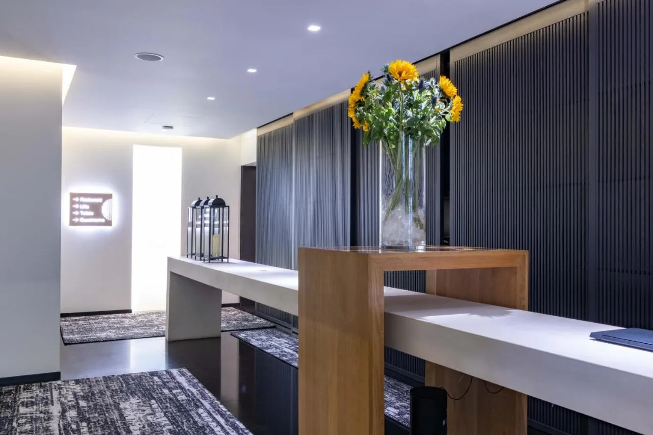 a vase of flowers on a table in a lobby at La Suite West - Hyde Park in London