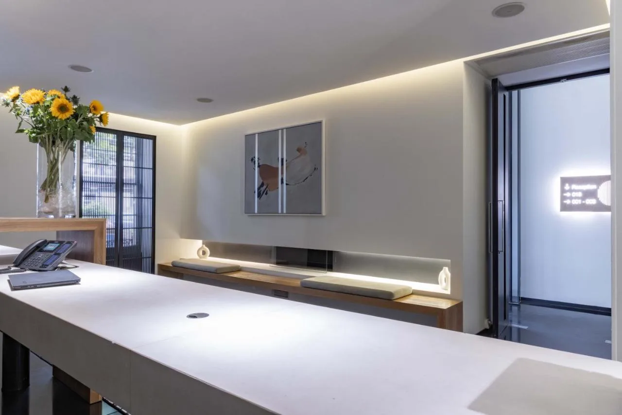 a room with a table with a vase of flowers at La Suite West - Hyde Park in London